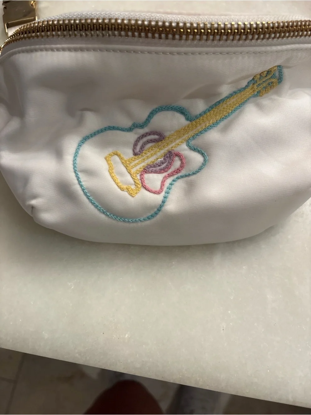 Stoney Clover Lane white pouch with teal, yellow, and pink embroidery